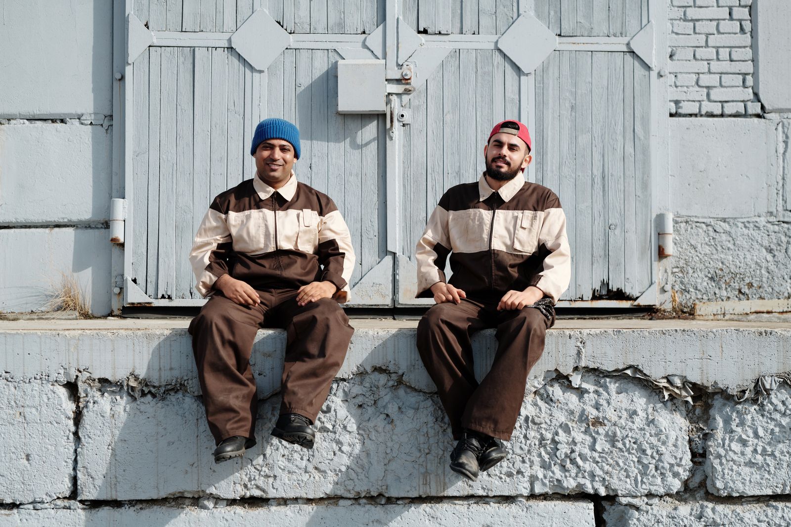 Two uniformed plumbers on a job site