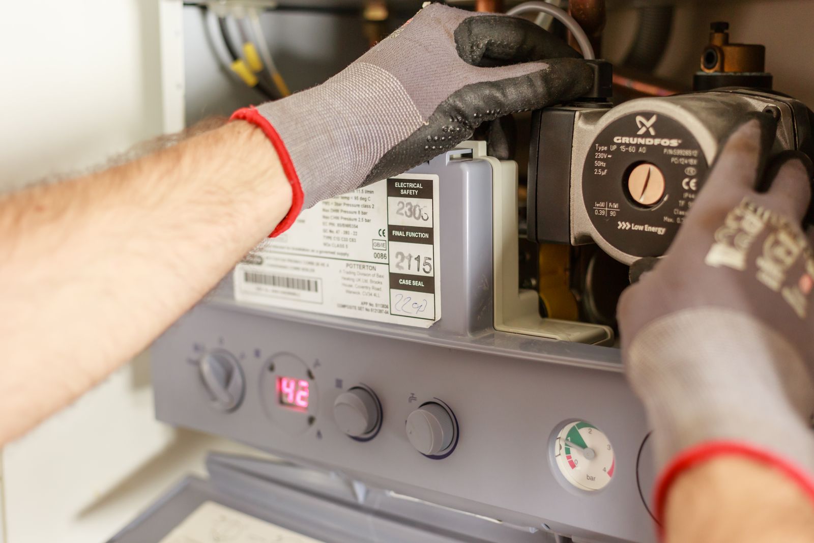 Technician in gloves servicing a water heater